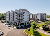 Thumbnail 7 of 22 - Modern apartment building exterior with parking at Timber Club Apartments, St. Peters, MO