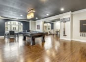 Thumbnail 3 of 63 - a game room with a pool table and a bar at Vanguard Crossing, St. Louis