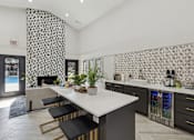 Thumbnail 34 of 44 - a kitchen with a marble counter top and a dining table at Wellington at Willow Bend Apartments, Plano, TX