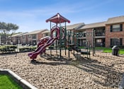 Thumbnail 32 of 44 - our apartments have a playground with a slide and picnic table at Wellington at Willow Bend Apartments, Plano, TX