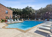 Thumbnail 1 of 44 - our apartments have a large swimming pool and lounge chairs at Wellington at Willow Bend Apartments, Texas