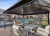 Thumbnail 31 of 44 - a patio with couches and chairs and a table at Wellington at Willow Bend Apartments, Plano, Texas
