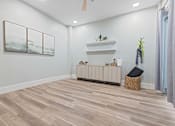 Thumbnail 38 of 52 - A room with a wooden floor and a painting on the wall at Aster Apartments, Beachwood Ohio