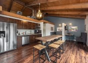 Thumbnail 24 of 32 - Clubhouse Kitchen Breakfast Bar with Stools at Whisper Hollow Apartments, Maryland Heights, MO