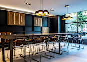 Thumbnail 6 of 29 - A modern dining room with a long table and chairs.
