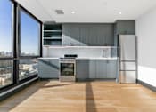 Thumbnail 12 of 29 - A modern kitchen with a view of the city.