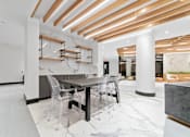 Thumbnail 27 of 29 - A modern dining area with a table and chairs.