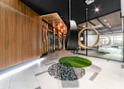 Thumbnail 3 of 29 - A modern interior with a green circle on the floor.