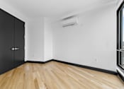 Thumbnail 24 of 29 - A room with black cabinets and wooden flooring.