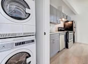 Thumbnail 6 of 7 - a laundry room with a washer and a dryer in it