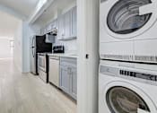 Thumbnail 7 of 7 - a laundry room with a washer and dryer and a refrigerator
