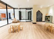 Thumbnail 10 of 37 - Childrens playroom with wooden furniture and chalkboard at 1134 Fulton Street Apartments, Brooklyn, 11216