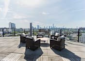 Thumbnail 21 of 37 - Rooftop terrace with seating and skyline views at 1134 Fulton Street Apartments, Brooklyn, 11216