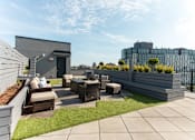 Thumbnail 18 of 37 - Rooftop terrace with lounge seating and artificial grass at 1134 Fulton Street Apartments, Brooklyn, New York