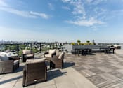 Thumbnail 17 of 37 - Rooftop deck with skyline views and dining areas at 1134 Fulton Street Apartments, Brooklyn
