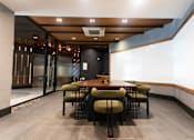 Thumbnail 6 of 37 - Private dining room with wood table and upholstered chairs at 1134 Fulton Street Apartments, Brooklyn, NY