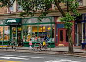 Thumbnail 50 of 56 - a man walking down the street with a bike at The Paxton, Brooklyn, New York