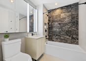 Thumbnail 42 of 56 - a bathroom with a white toilet and a shower and a sink at The Paxton, Brooklyn