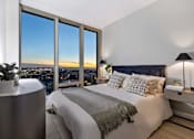Thumbnail 41 of 56 - a bedroom with a bed and a view of the city at The Paxton, Brooklyn