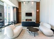 Thumbnail 9 of 56 - A modern living room with a fireplace and a black coffee table.