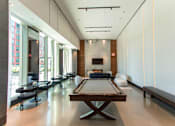 Thumbnail 8 of 56 - A billiard table is in the middle of a room with a fireplace.