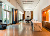 Thumbnail 6 of 56 - A modern kitchen with a marble countertop and a long table.