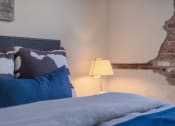 Thumbnail 40 of 42 - a bedroom with a bed and a lamp at The 22 Apartments, St. Louis