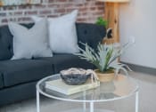 Thumbnail 34 of 42 - a coffee table with a book and a potted plant on top of it at The 22 Apartments, Missouri, 63103