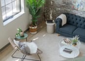 Thumbnail 19 of 42 - a living room filled with furniture and a large window at The 22 Apartments, St. Louis Missouri