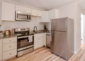 Thumbnail 11 of 11 - a kitchen with stainless steel appliances and white cabinets