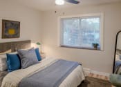 Thumbnail 1 of 11 - a bedroom with a large bed and a window