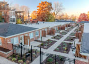 Thumbnail 2 of 11 - an aerial view of a community garden with brick buildings