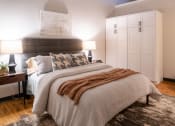 Thumbnail 16 of 28 - a bedroom with a large bed and white cabinets at The Draper, Missouri