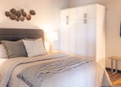 Thumbnail 12 of 28 - a bedroom with a large bed and a white wardrobe at The Draper, Missouri