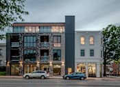 Thumbnail 1 of 50 - the exterior of a building with cars parked in front of it