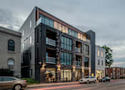 Thumbnail 50 of 50 - a large building on a city street with cars