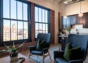 Thumbnail 10 of 42 - a living room filled with furniture and a large window at The 22 Apartments, St. Louis, 63103