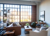 Thumbnail 7 of 42 - a living room filled with furniture and a large window at The 22 Apartments, St. Louis, 63103