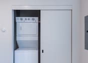 Thumbnail 46 of 61 - A white oven and fridge are in a small kitchen.