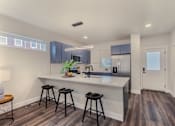 Thumbnail 4 of 27 - A kitchen with a bar stool and a counter.