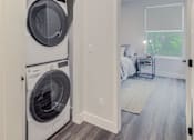 Thumbnail 20 of 27 - A laundry room with a washer and dryer in it.