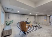 Thumbnail 26 of 27 - A room with concrete walls and a striped rug on the floor.