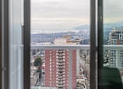 Thumbnail 2 of 13 - A view of a cityscape through a window.
