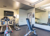 Thumbnail 11 of 15 - a gym with treadmills and other exercise equipment at the belgard apartments