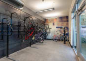 Thumbnail 13 of 15 - a row of bikes hanging on a wall in a room with a window