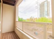 Thumbnail 6 of 15 - a balcony with a large window and a view of a building