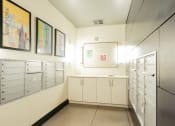 Thumbnail 9 of 15 - a utility room with white cabinets and drawers and pictures on the wall