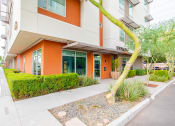 Thumbnail 15 of 15 - an orange building with a tree in front of it