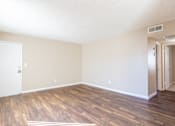 Thumbnail 5 of 22 - an empty living room with a hard wood floor and white walls