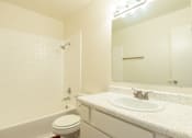 Thumbnail 4 of 22 - a bathroom with a sink and a tub and a mirror